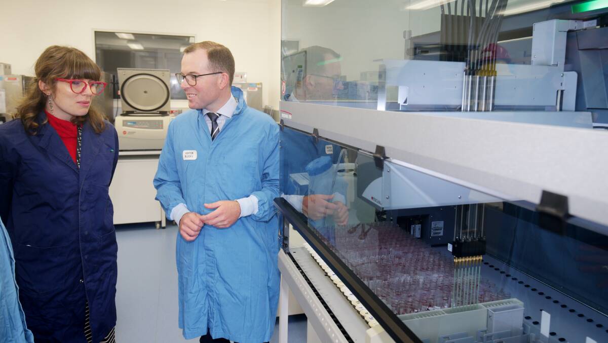 Former Agriculture Minister Adam Marshall discusses the workings of a robotic liquid handling machine with NSW DPI technical officer of serology, Monica Suann, during a visit to the Elizabeth Macarthur Agricultural Institute laboratory in 2021.
