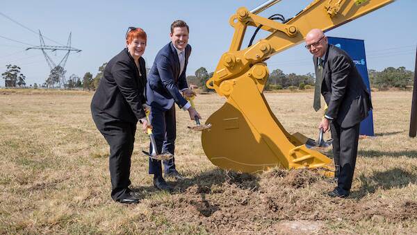 Liverpool City Council Mayor, Wendy Waller with AMP Capital managing director office and industrial, Luke Briscoe and WesTrac NSW/ACT chief executive, Greg Graham are helped by a Caterpillar 325F excavator to break the ground at the site of WesTrac’s new 24,000 sqm purpose-built facility.