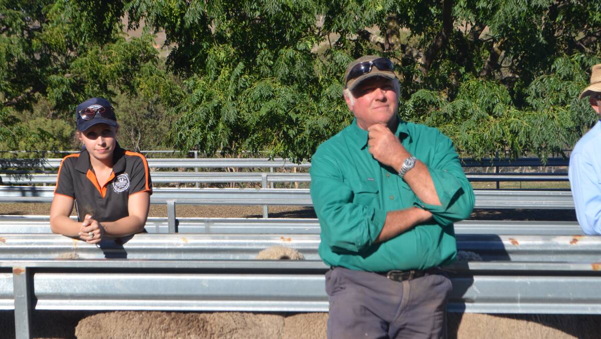 Kelly Armour and her father Tony listen intently to the judges comments on their young Merino ewes.