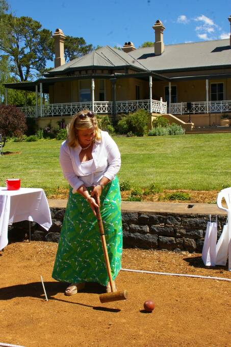 MLC, Bronnie Taylor, Nimmitabel, tried her hand at croquet on the lawn in front of the "Springwell" homestead.
