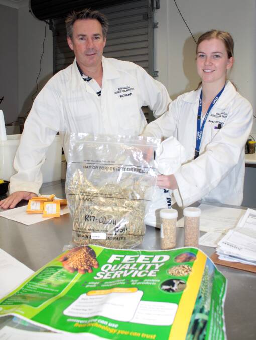 Testing feed: NSW Department of Primary Industries is finding huge variations in the feed quality of hay made from this year's failed canola crops. DPI analytical chemist, Richard Meyer and technical assistant, Anna Richards, prepare hay, silage and grain samples for testing. Photo: supplied.
