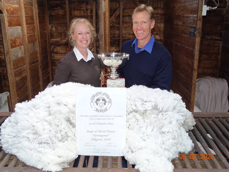 David and Angie Waters of Tarrangower of the New England Region with their Cleckheaton Grand Champion Trophy for the best overall fleece. Photo: ASWGA