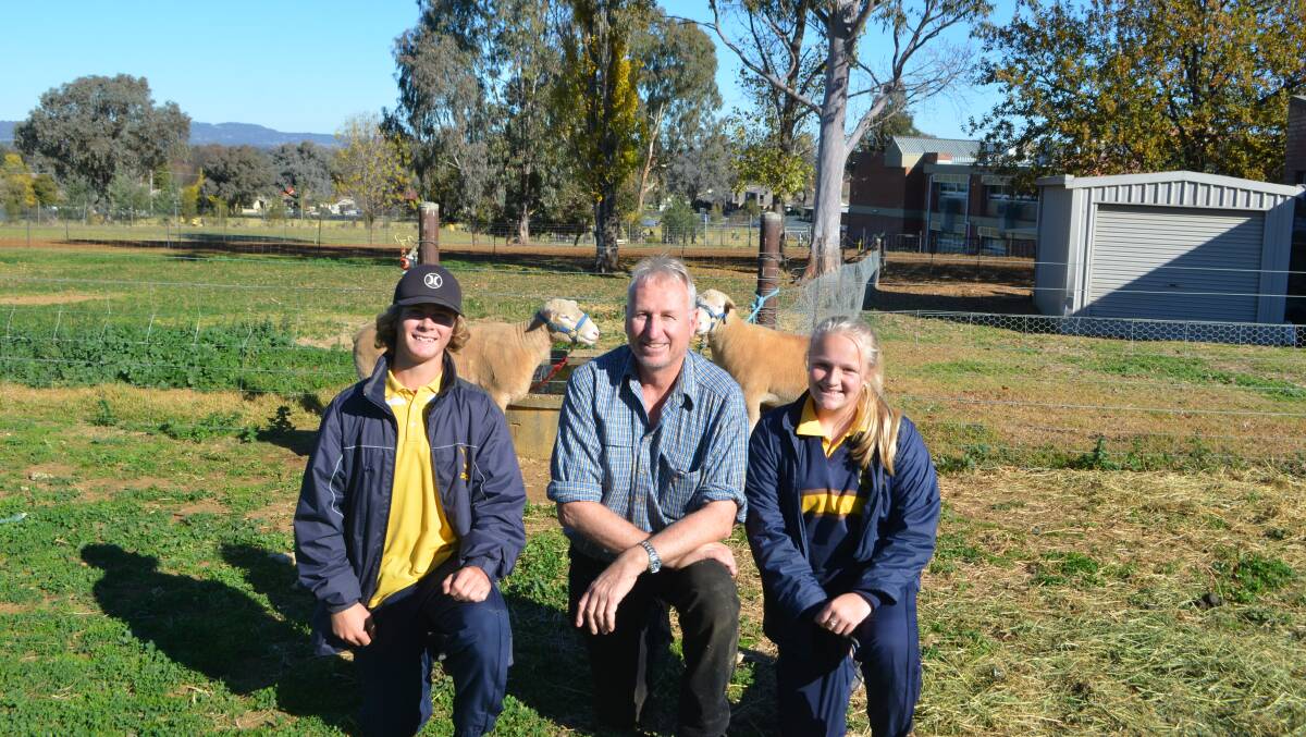 Taking time out from preparing their school show team for the Holbrook Sheep and Wool Fair to be held 14 to 16 June. Agriculture students at Kooringal High School, Troy Piercy and Jess Meyers, with (centre) agiculture teacher Stephen Reynolds.