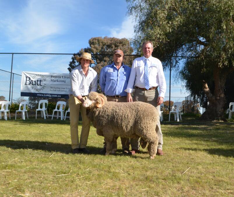 Ben Patrick, Yarrawonga Merinos, Harden, with the $16,000 ram purchased by Phil Butt for his parents, Keith and Gail Butt, Young, and guest auctioneer, Paul Dooley.