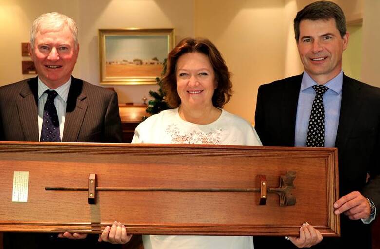 Hancock Prospecting chairman, Gina Rinehart, and chief executive officer, Garry Kort, receive a Kidman branding iron from managing director, Greg Campbell (left), during their visit to S.Kidman and Company's head office after ownership transferred to the Hancock-Shanghai CRED partnership, Australian Outback Beef.