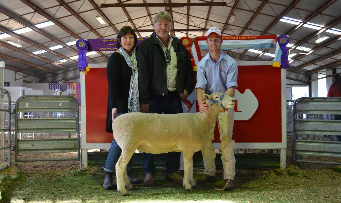 Deb Stone and Craig Graham, Glencorrie Pty Ltd, SA, with their $900 top price ewe purchase held by Ross Gilmore, Tattykeel stud, Oberon