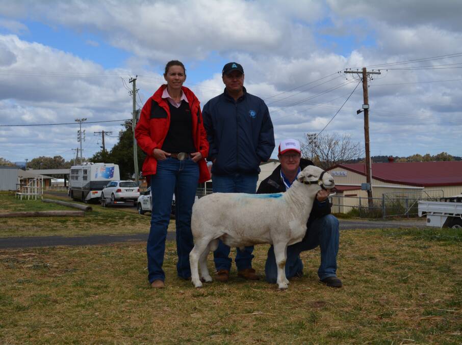 Purchasers Leanne and Rod Middleton, Lake Cargelligo, with their top price Australian White ram held by Timor sheep stud principal Jason Barker, Parkes. 