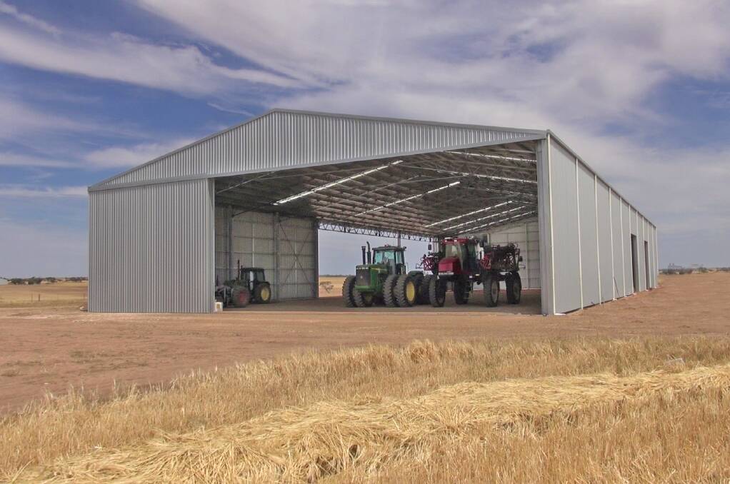 UNDER COVER: The Rundle family, Kulpara, are delighted with their new combined machinery shed and farm workshop.