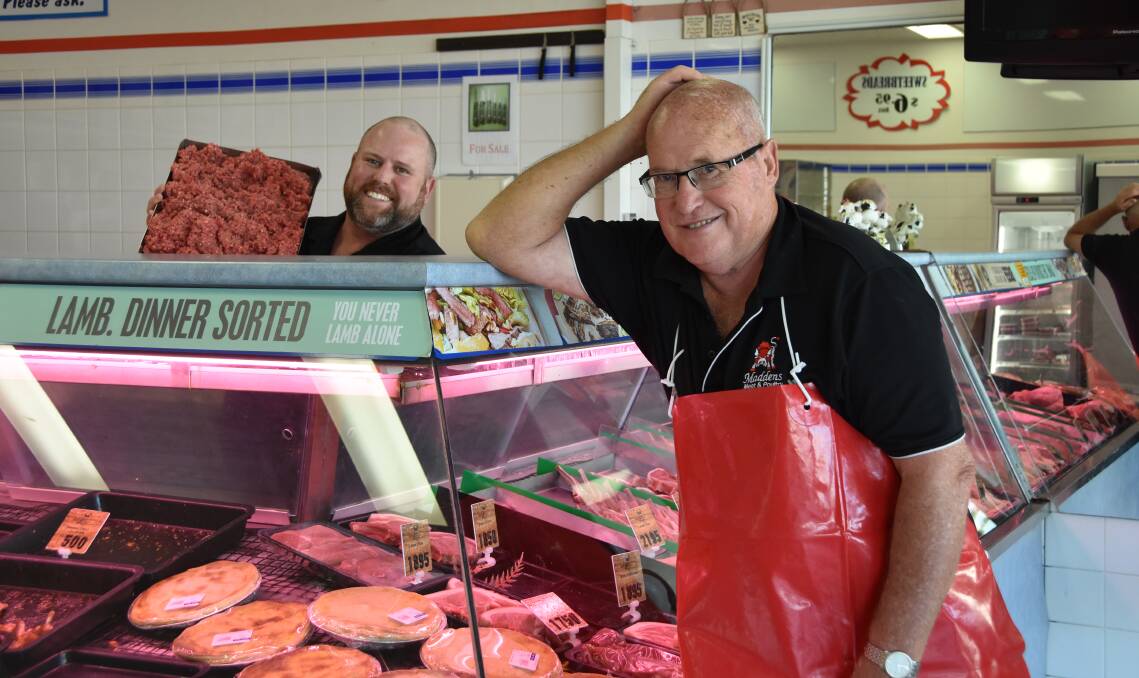 BACK ON THE JOB: John Madden had to interrupt retirement to help son Steve serve up the mince in his Queensland butcher shop.