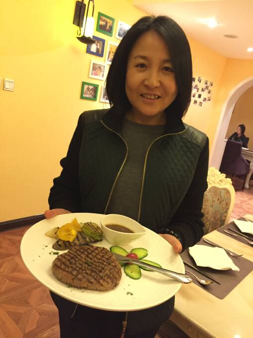 Chinese restaurant owner Maggie Li with her Western style steak.