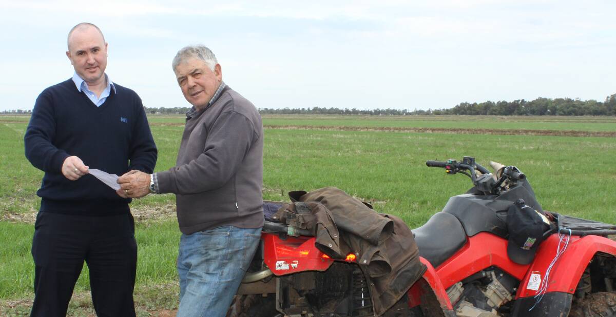 Murrumbudgee Irrigation communications officer Peter Duncan discusses with Griffith rice farmer, John Bonetti, MI’s decision to remove their rice growing rules.