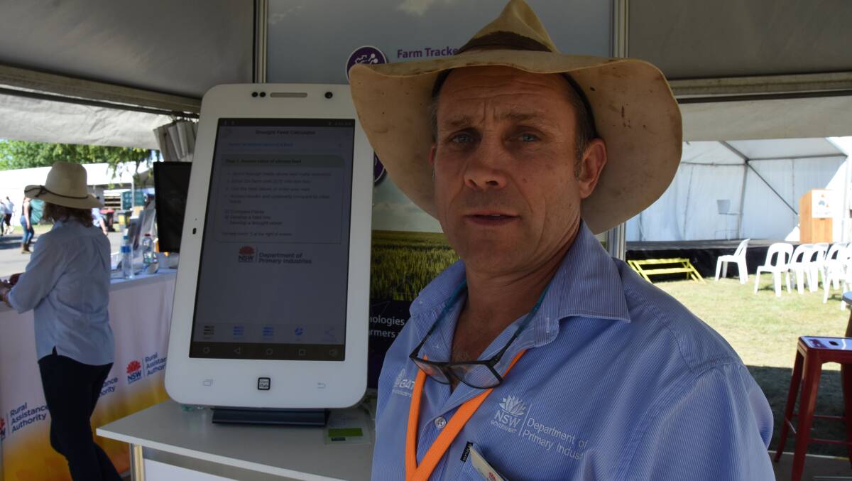 Geoff Casburn with a giant phone running the drought feed app. There are new updates planned for early next year. PHOTO - Dan Pedersen.