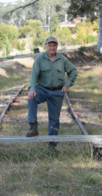 Bobby Burgun stands on the disused rail line that cuts through his property "Wattledale" at Tumbarumba. He's not the only one who doesn't want the rail trail.