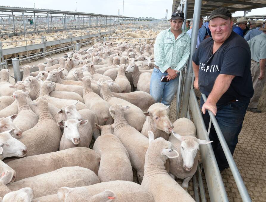 Bill Tomlinson, "Rosehill", Trundle, (right) with Gerard and Partners agent, Stephen Tomlinson, Young, beside Bill's pen of second cross heavy prime lambs that sold for $166 a head earlier this month.