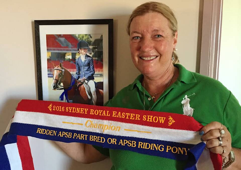 Mrs Hughes with Denhue Royal Design's champion ribbon from 2016 and picture of Ella Smith aboard. "It was such a proud moment when this championship was awarded as I bred this pony".