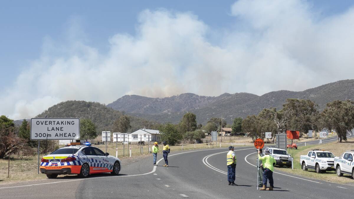 Watch and act: Police and emergency services block the New England Highway at Moonbi near Tamworth on Tuesday as a fire rages. Photos: Peter Hardin, Janie Kibble