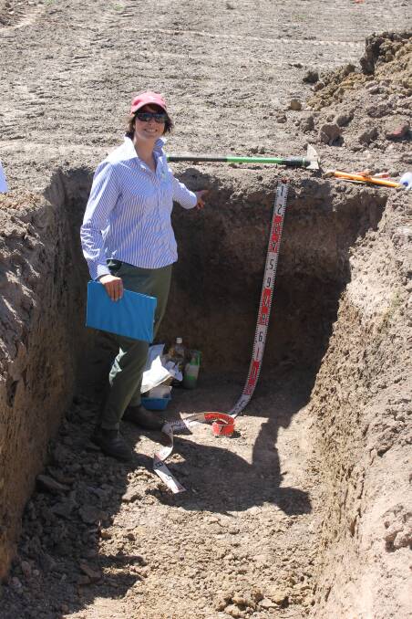 Lisa Miller, Southern Farming Systems (SFS), uses a soil pit to explain how lime moves through the earth at SFS's AgriFocus event last month.