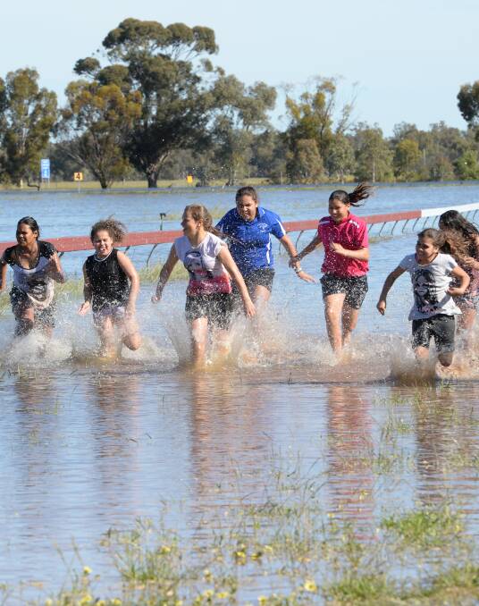 No horses, no worries. These local Condobolin girls make their own fun in flood water during September this year. Photo by Rachael Webb.