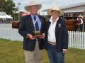 Glen Pfeffer receives a trophy from Wendy Cole, Kenrol Brahmans, Rockhampton, Qld, to recognise his 40 years with Mogul Brahmans, Casino, and his last Sydney Royal.