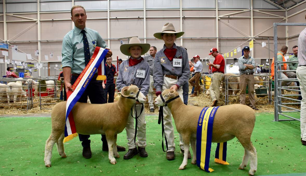 Champion Dorset Horn ewe and reserve with Maisie Bell and Kirra Homsley, and judge, James Corcoran, Boorowa.