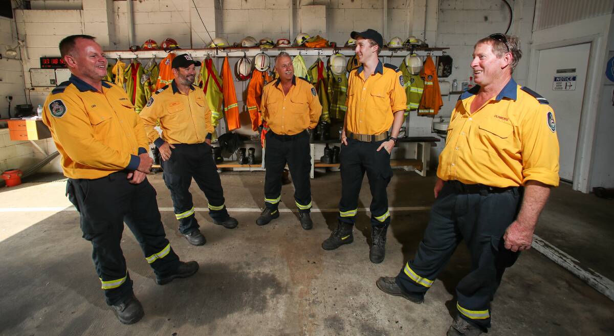 Dunmore RFS members Les Millier, Greg Hardy, Daryl Kimmins, Cameron Chisholm and Tim Anderson relive the moments they overrun with fire when protecting a home. Picture: Adam McLean