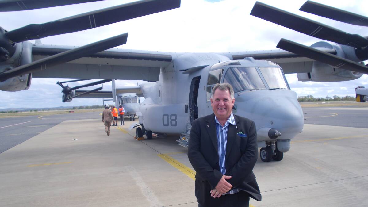 Rockhampton Regional Council deputy mayor and airport portfolio leader Neil Fisher, in front of a US Marines Bell Boeing V-22 Osprey, says the government-imposed security changes have been very costly. Picture supplied.