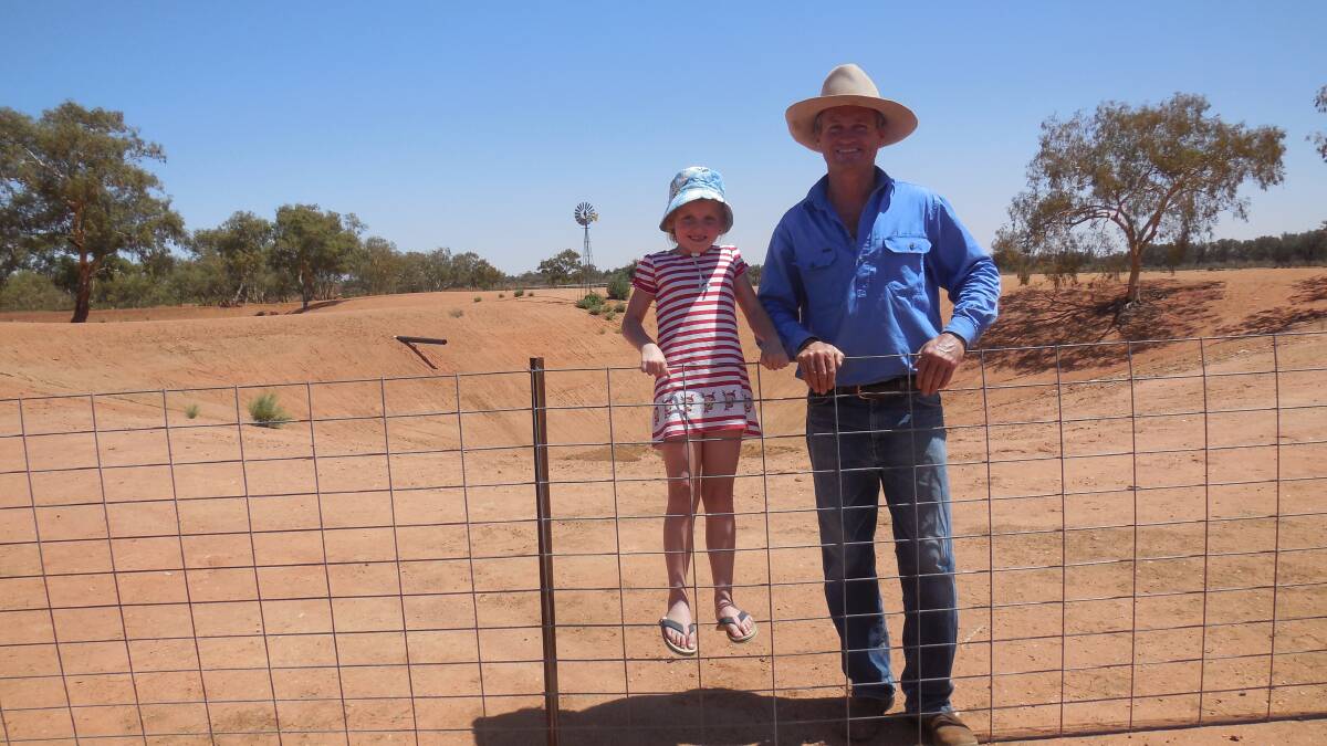 Lachlan Gall and his daughter Georgina at the Creek Tank on their property Coogee Lake Station, which is still dry. Photo: Joanna Gall