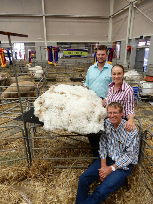 Hayden, Bec and Malcolm Cox from Bocoble Merino stud, Mudgee, with the fleece donated to the Flock to Baggy Green project. Photo by Samantha Townsend.