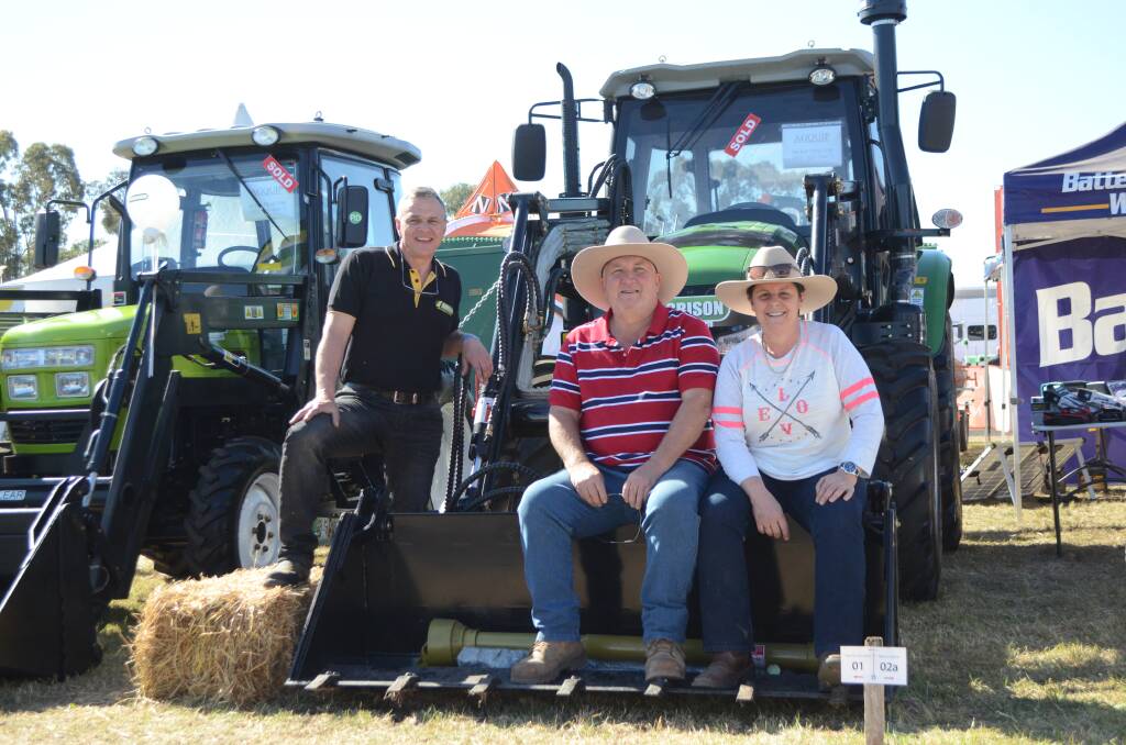 Agrison operations manager Sol Ozkaya with Kevin and Karen Scaife, "Kameruka", Tea Gardens, who bought a 100 horsepower CDF tractor.