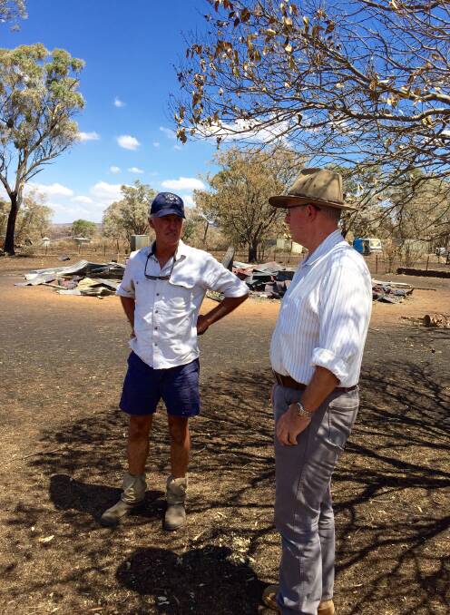 Local Saxon McGregor (left) and Parkes Nationals MP Mark Coulton stand in front of the remains of the St. John the Evangelist Anglican Church at Uarbry that was torched by the ruthless Sir Ivan fire.