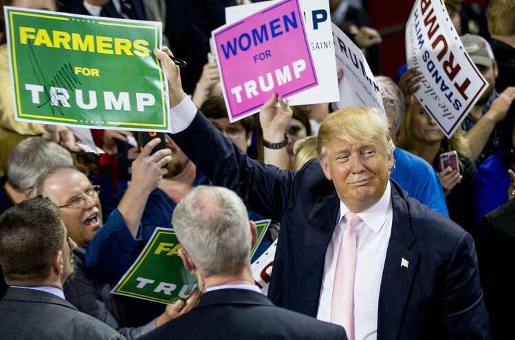 Donald Trump holding a "Farmers for Trump" sign during the US presidential election campaign.
* Picture supplied Farmers for Trump Facebook page. 