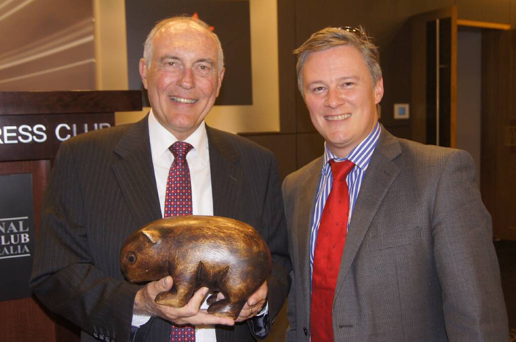 Former Nationals leader Warren Truss and Animal Medicines Australia CEO Duncan Bremner with the wooden wombat on the 2013 election trail.
