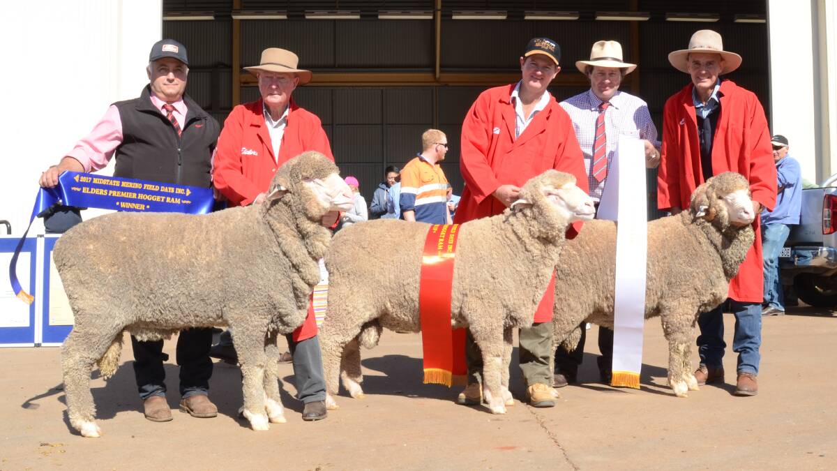 Scott Thrift, Edlers, Dubbo, presents champion ribbon to the Darriwell stud poll ram held and exhibited by Ray Jones, Darriwell Poll stud, Trundle; second place to Weealla Poll stud, Balladoran and held by Stuart McBurnie; judge James Barron, Adina stud, Cooma;  and third place to Towalba stud held and exhibited by Garry Kopp, Towalba stud, Peak Hill.