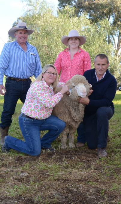 Anthony and Libby James, with daughter, Caitlin, "Springvale", Coolah, and their $4400 top-priced ram held by Allendale principal, Tony Inder, Wellington.