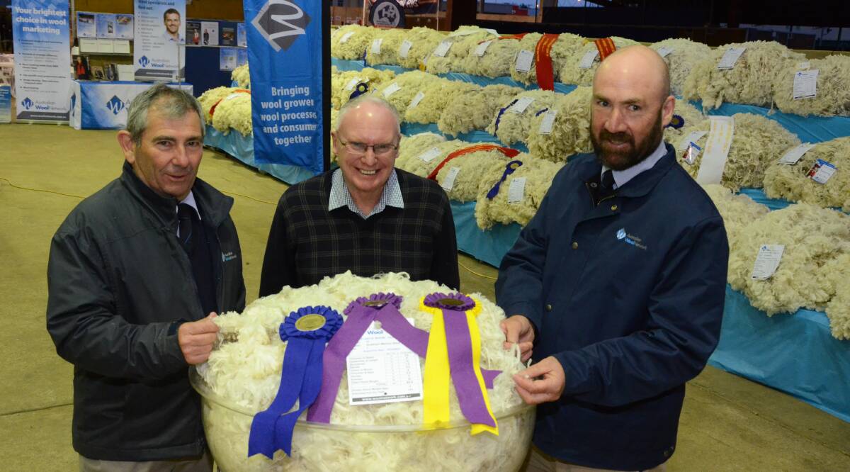 Back-to-back supreme fleece win for Grathlyn stud, Hargraves, with Max Rayner and AWN judges Harold Manttan, Uralla (left) and Stephen Maunder, St George, Qld (right).