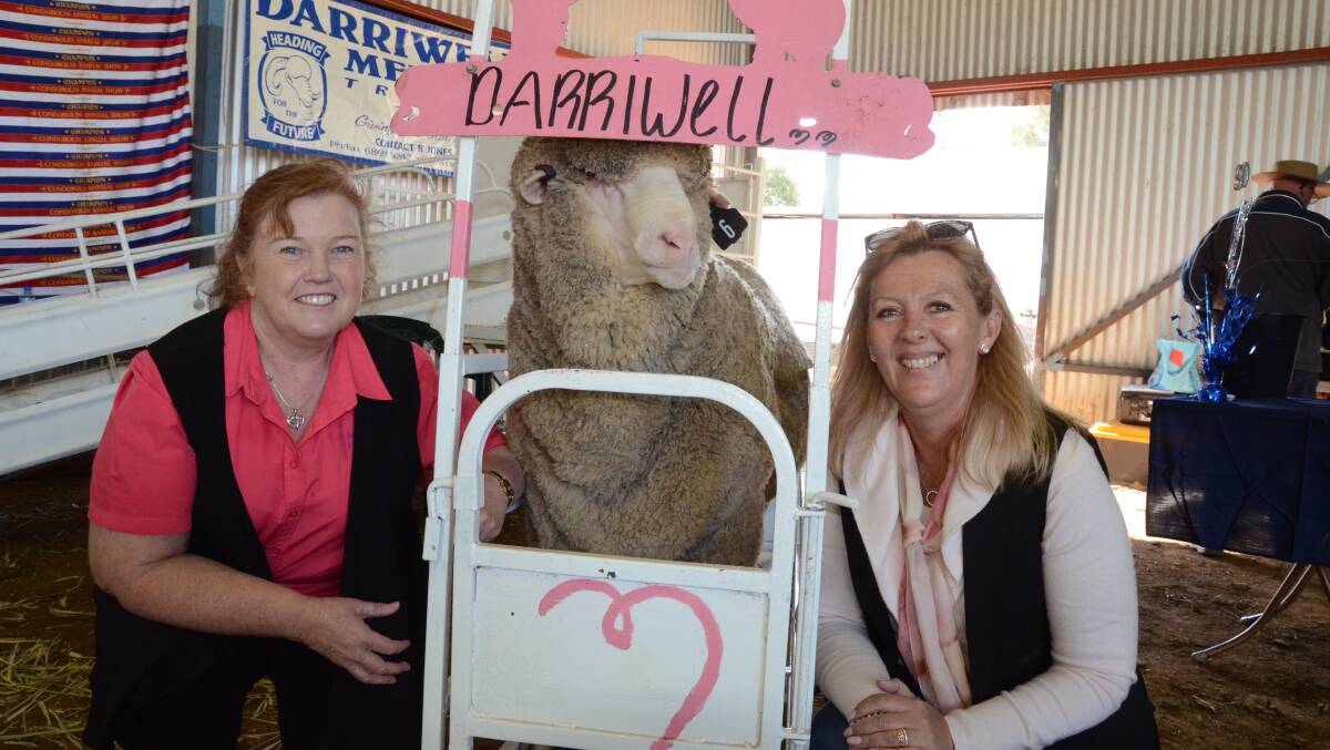 Lachlan Health Service McGrath Foundation community breast care nurse, Diannne Green and Carolyn Keep, "Havilah", Trundle, pal up to the donated Poll Merino ram which sold at $3000 with the proceeds going to the McGrath Foundation.