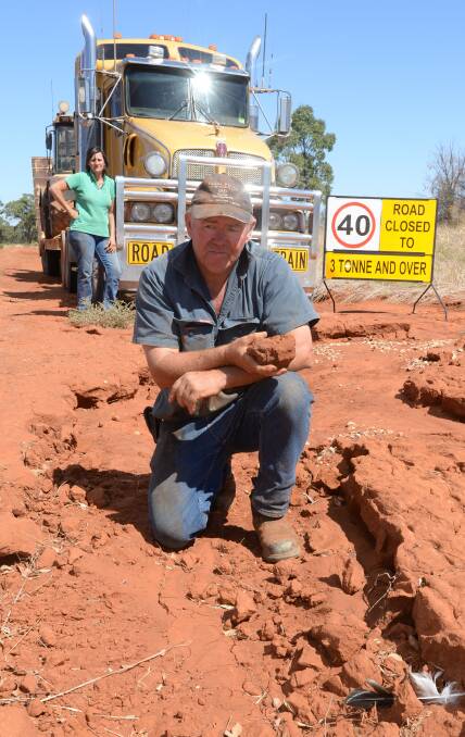 Peter McCarten in one of the many ruts running across and through McCartens Lane between Weethalle and Rankins Springs, as his wife, Meegan, who is just as frustrated with Bland Shire Council, looks on from their prime mover.