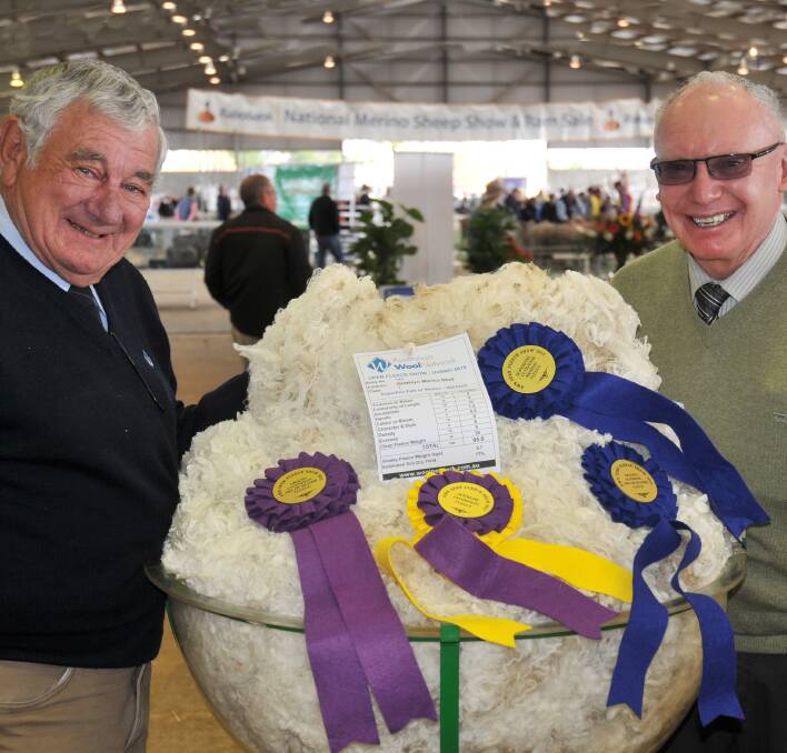 Co-judge Peter Meakes, Senior Wool Valuer, Australian Wool Network, Newcastle, with long-standing client Max Rayner, Hargraves, and Grathlyn's supreme fleece of the show.