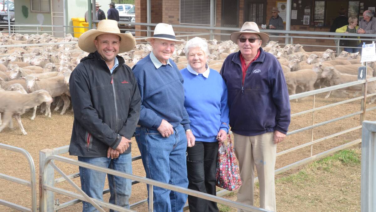 Christie and Hood's Tim Wiggins, Narromine, with Merino ewe vendors Kevin and Rose Marie Perry, "Rothsay", Quambone, and Colin Hood, in their $185 top Merino ewe pen.