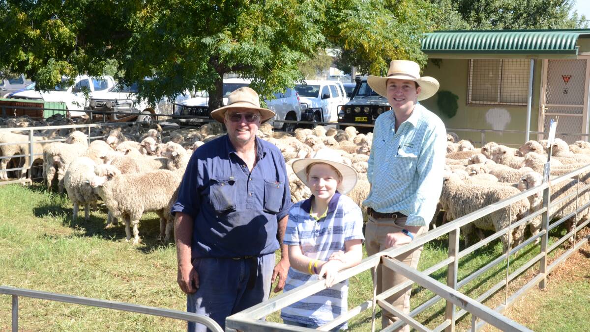 Tony Smith, "Broadwater", Warren, and daughter, Ruby, 10, with Ryan Johnston, Landmark Wilson Russ, Warren, and the pen of 126 Merino ewes from Haddon Rig, Warren, two years and October shorn Mr Smith paid $175 a head.