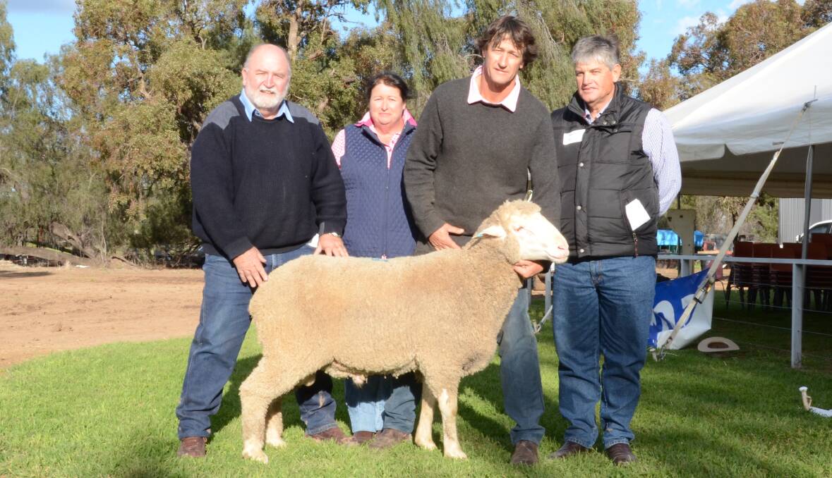 The $8000 top-priced ram a son of new sire MD13-7021 (Tom) with Macquarie stud co-principal, Greg McCann; buyers Di Perry and Stephen Perry, (right) "Wyndabyne", Warren, while co-principal, John Nadin holds the ram.