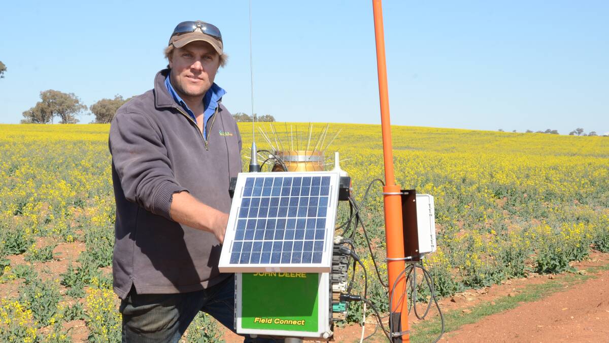 Nathan Simpson checks the "Gateway" serving three John Deere Field Connect soil moisture monitors (probes) installed in 100 hectares of Victory 7001 canola as a trial in a sloping paddock of three soil types at "Binginbar", Gollan.