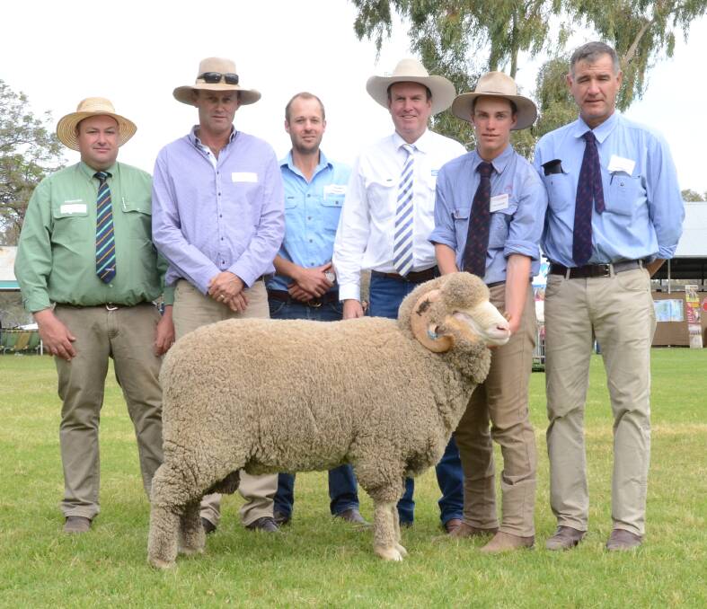 The $16,000 Egelabra sale-topper with Brad Wiulson, Landmark, Dubbo; Dave Motley and Campbell Keene of Gerar Station, Nyngan; Paul Dooley, Tamworth auctioneer; Tom Cameron holds the ram with Egelabra manager, Cam Munro.