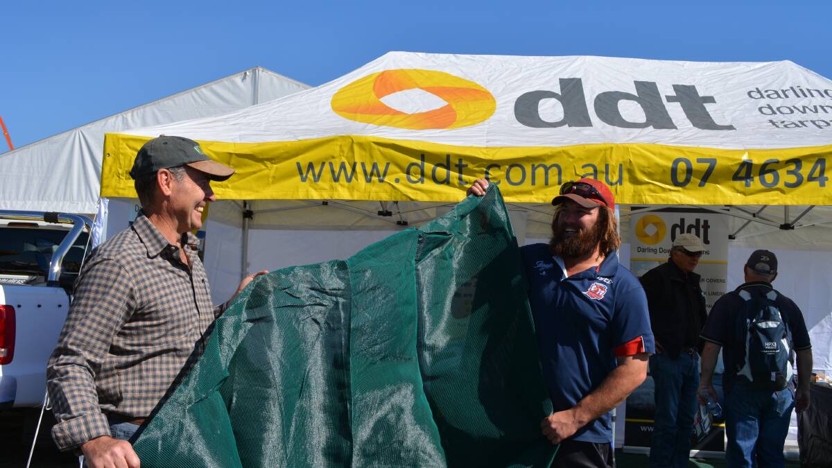 Darling Downs Tarpaulins managing director, Michael Ryan, shows off shade cloth options to Grafton's Tim Tilse. DDT also do bunker covers to protect stored grain. 