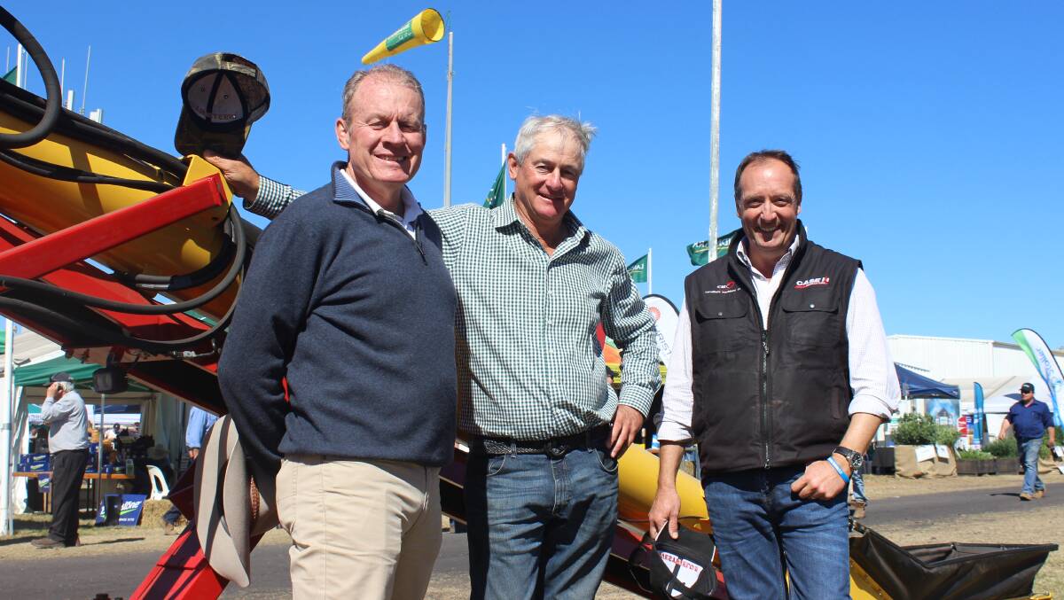 Brian Carruthers, Young, with Roland Schmelzer, Westfield Augers, and Peter Burey, Kenway and Clark, Moree inspecting the new conveyor earlier this year at AgQuip. 