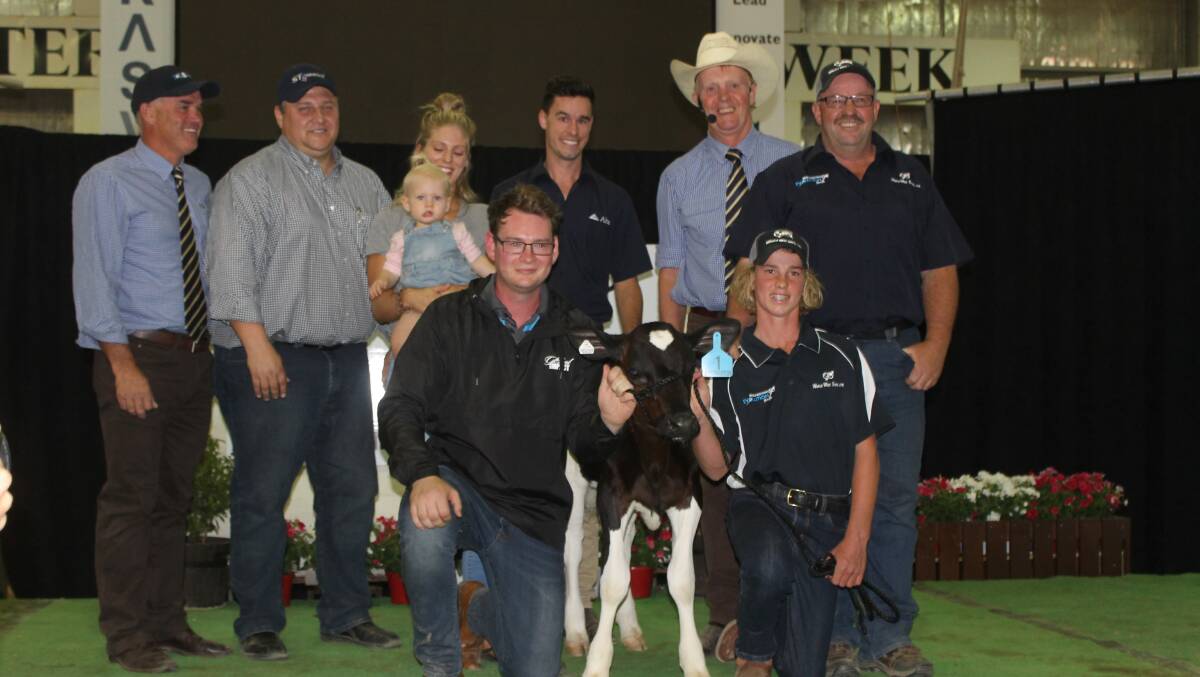 Celebrating the record-breaking heifer sale are Scott Lord, Dairy Livestock Services; buyer Dan Carroll, Sexing Technologies, Texas; vendors Ellie, baby Eva and Declan Patten and Callum Moscript; Brian Leslie, DLS; Mark Patullo, World Wide Sires, and handler Charlie Lloyd.