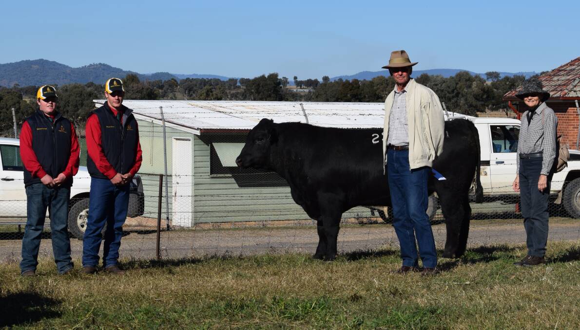 Farrer High School students Sam Colwel and Fraser Evans with purchasers of the $14,500 top-priced bull, Farrer L71, Greg and Kathie Tighe, "Kelso", Guyra. Photo supplied. 