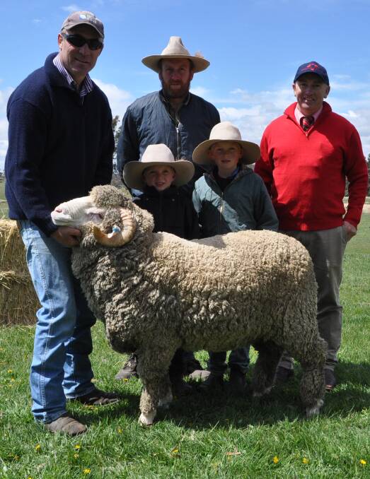 The $4000 top-price ram held by Simon King with purchaser Richard Maguire and boys Patrick and Clyde, Adaminaby, with Elders Cooma agent, Tim Schofield.