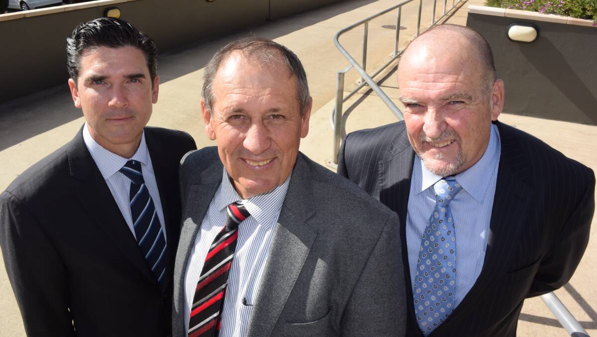 Central Queensland producer Cameron McIntyre, centre, with solicitors Damian, Bell, left and Dan Creevey, right, at the ACCC hearing in Toowoomba on Friday.