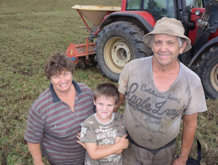 Bev and Max Saul with their grandson Chad at Taylors Arm. Their modified rotary hoe has its teeth cut in half to maintain summer kikuyu through to next season, while enough soil has been ripped to give winter rye a chance.